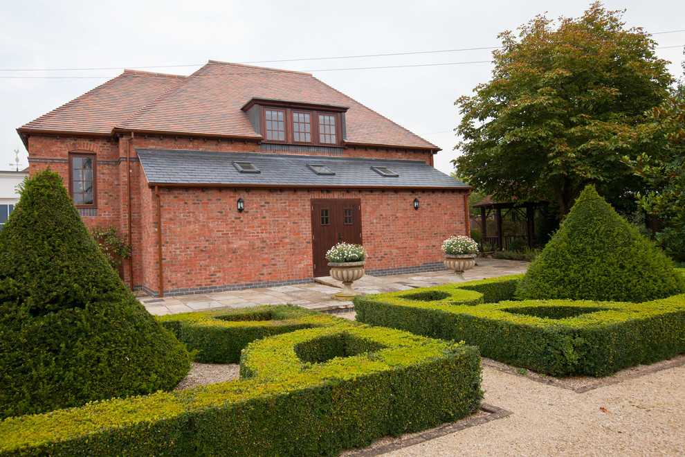 This is an example of a farmhouse courtyard formal garden in West Midlands.