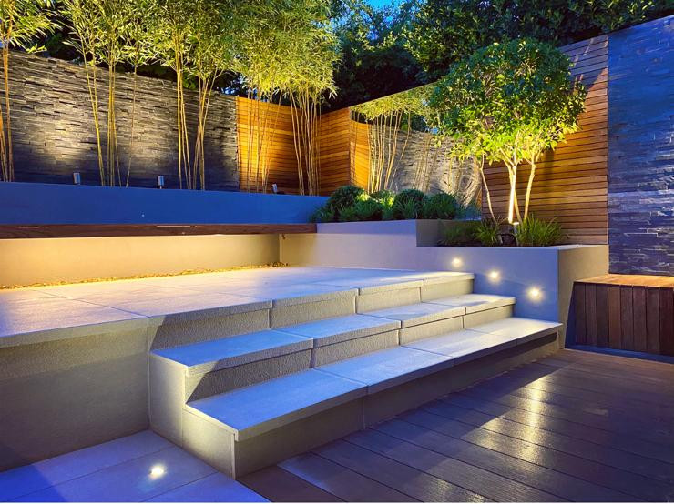 This is an example of a small contemporary back garden in London with a wood fence.