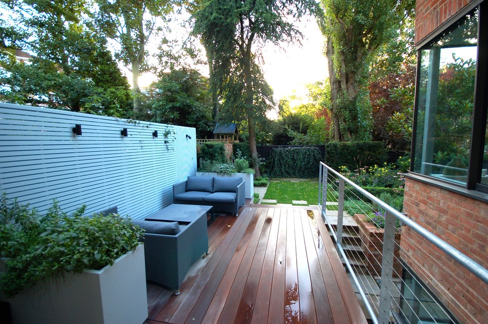 Photo of a small contemporary backyard landscaping in London with decking.