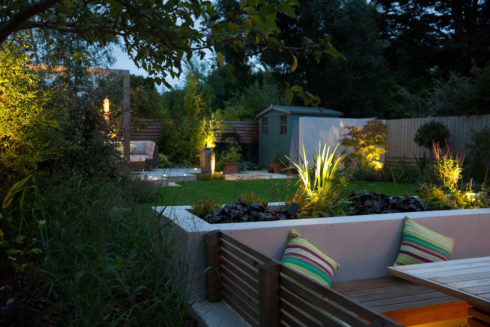 Inspiration for a small contemporary back formal partial sun garden in Cheshire with natural stone paving.