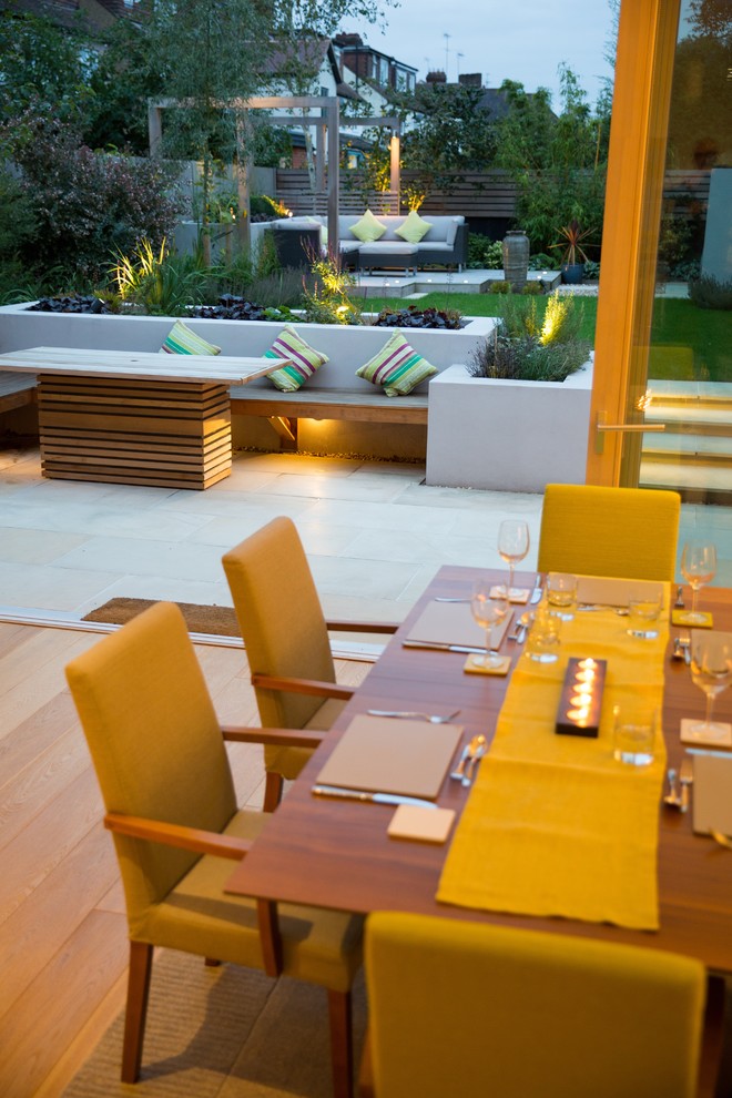 Inspiration for a small contemporary back formal partial sun garden in Cheshire with natural stone paving.