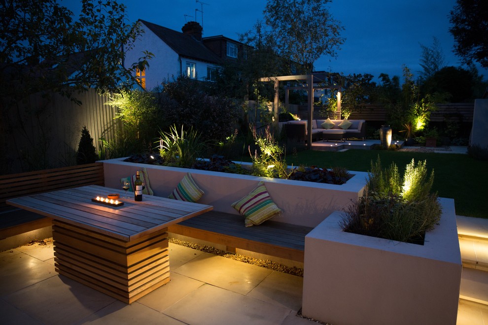 Design ideas for a small contemporary back formal partial sun garden in Cheshire with natural stone paving.