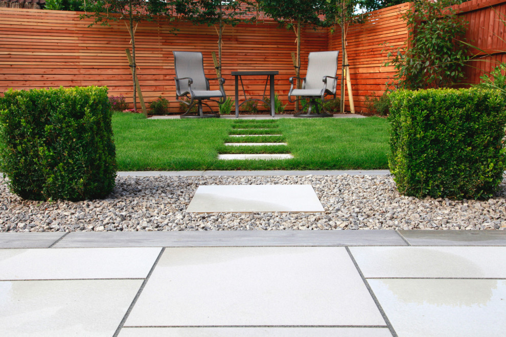 Medium sized contemporary back formal and private garden in Other with natural stone paving.