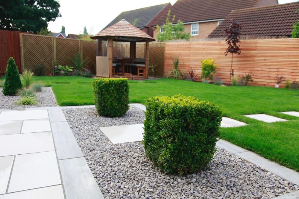 Design ideas for a mid-sized contemporary privacy backyard stone formal garden in Other.