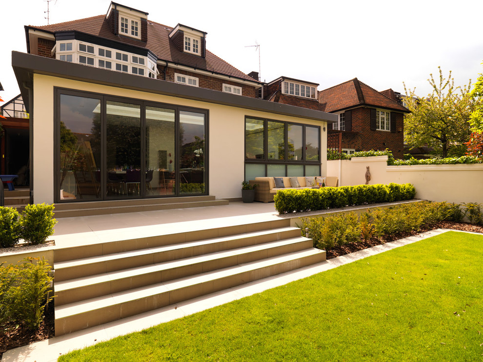 Photo of a contemporary full sun backyard landscaping in London with decking for summer.