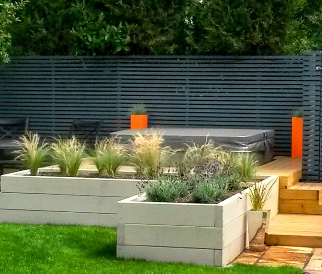 Contemporary Hot Tub Garden Raised bed with grasses and planters