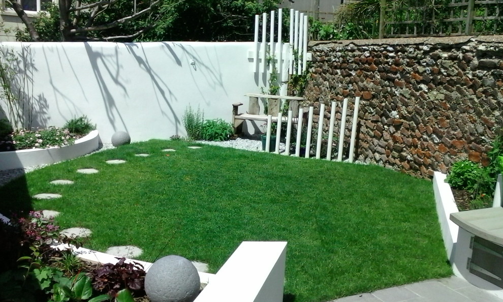 This is an example of a small contemporary garden in Sussex.