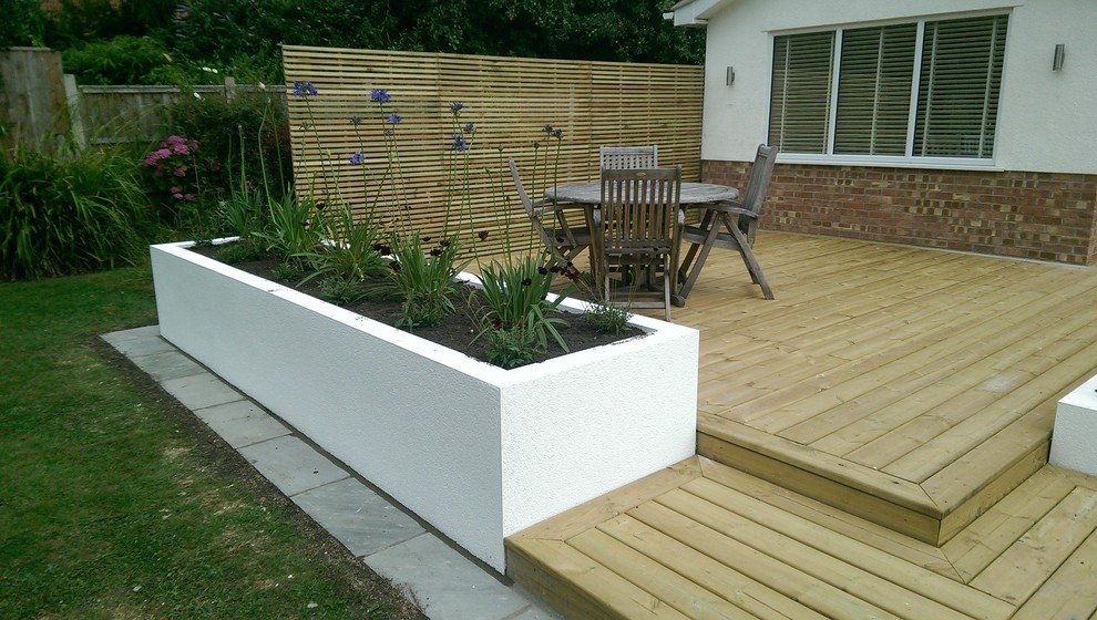 Contemporary softwood decking and rendered raised beds - Contemporary