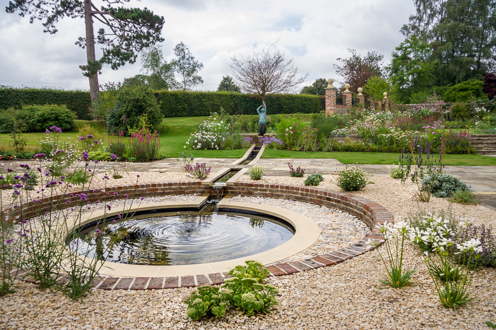 This is an example of a country garden in Hampshire with a water feature.