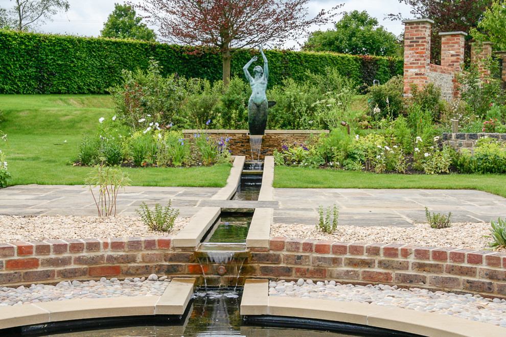 Photo of a farmhouse garden in Hampshire with a water feature.