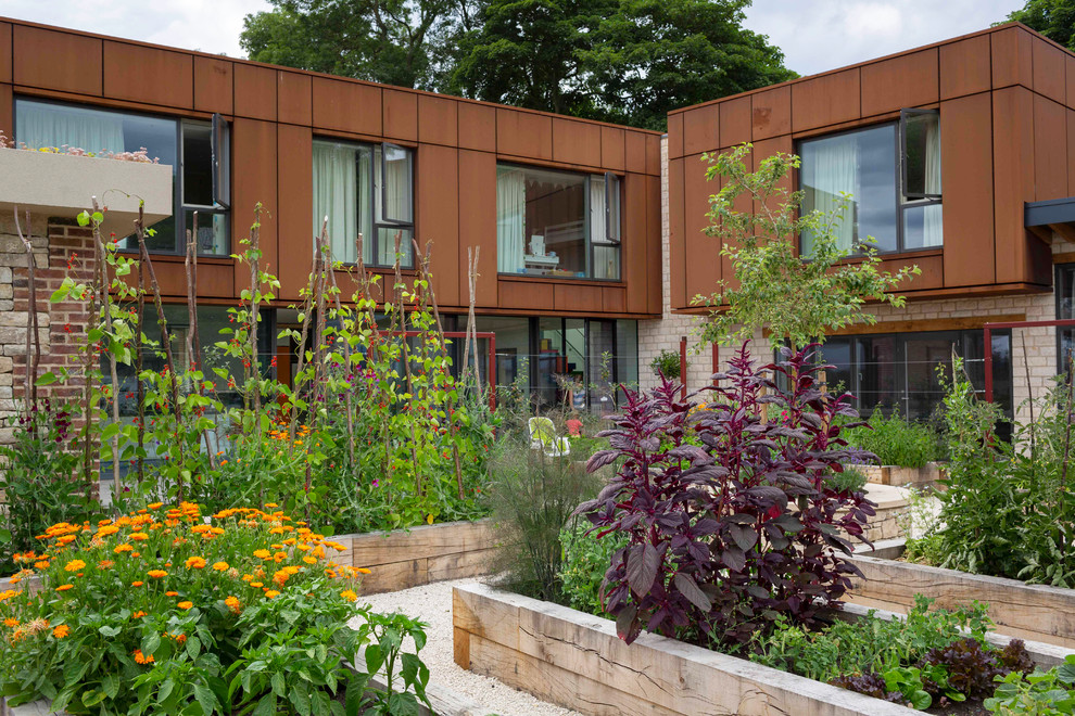 Design ideas for a farmhouse full sun gravel vegetable garden landscape in Other.