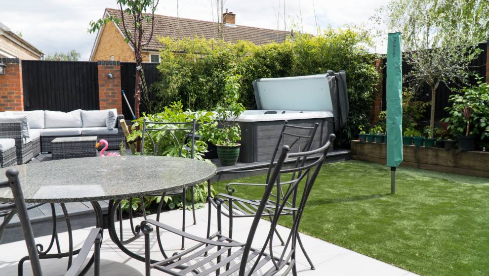 Design ideas for a small modern full sun backyard landscaping in Buckinghamshire with decking.