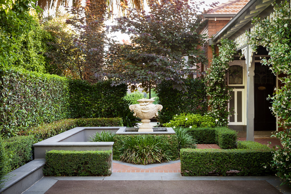 Photo of a medium sized classic front garden in Melbourne with a water feature.