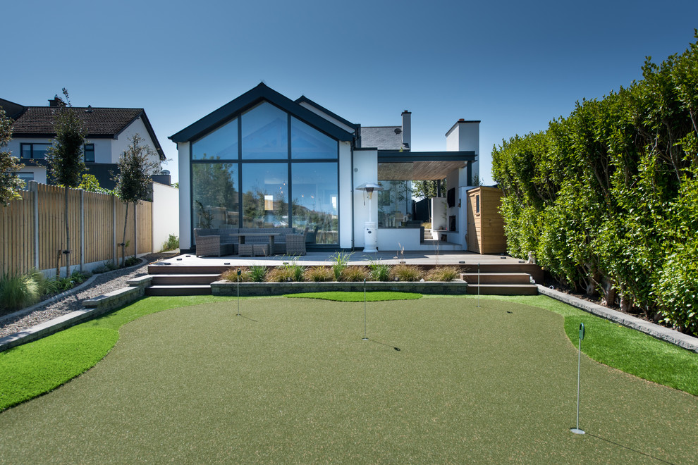 Photo of a medium sized contemporary back full sun garden for summer in Dublin with an outdoor sport court.