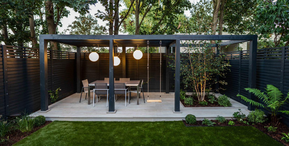 Photo of a medium sized contemporary back formal partial sun garden for summer in London.