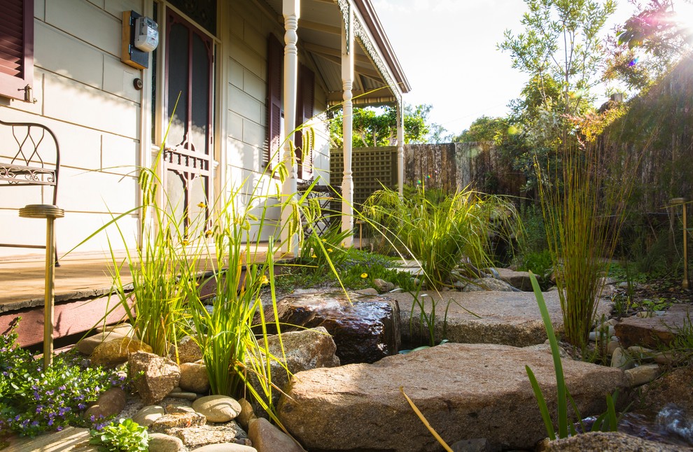 This is an example of a small front garden in Melbourne with a pond.