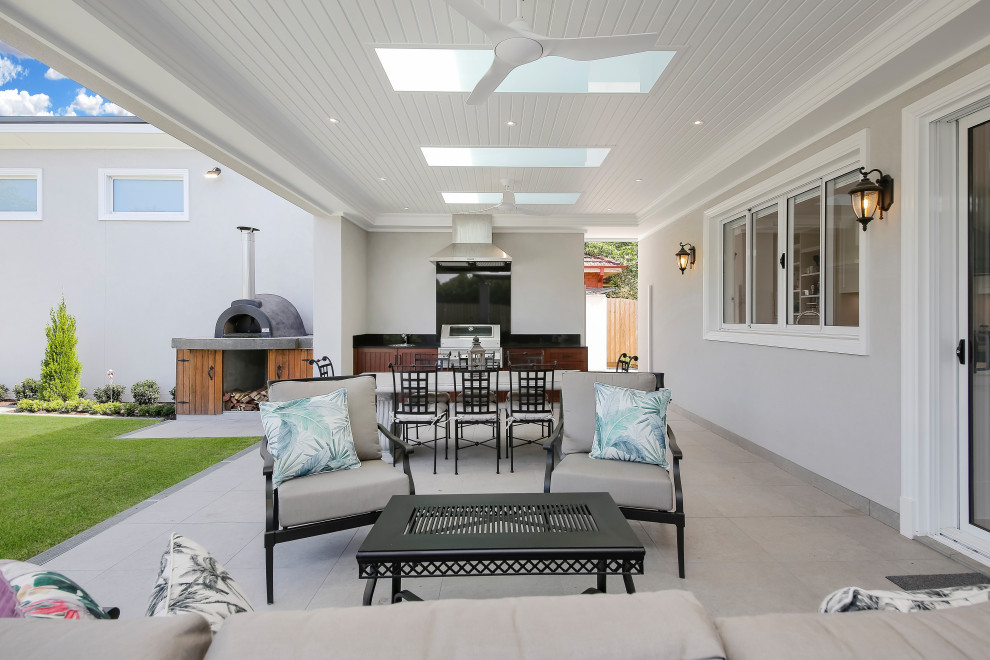 Large contemporary courtyard formal and private garden in Sydney with natural stone paving.