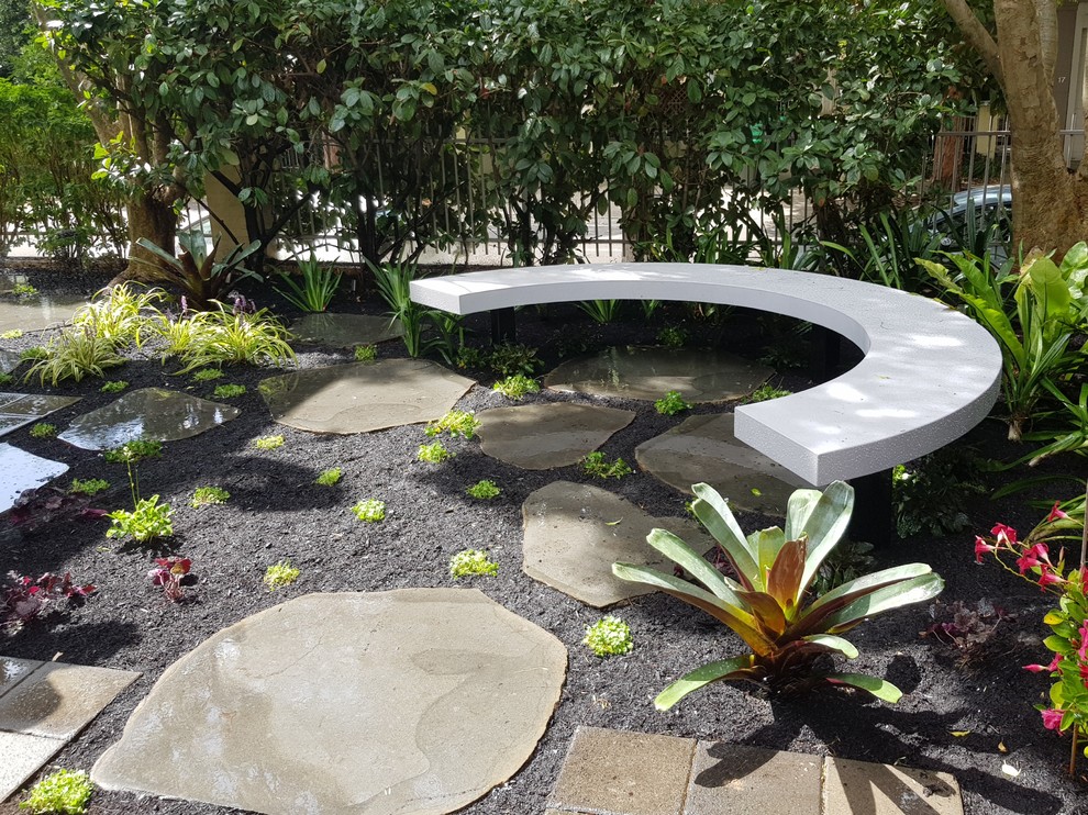 Cette image montre un jardin sur cour design avec des pavés en pierre naturelle.