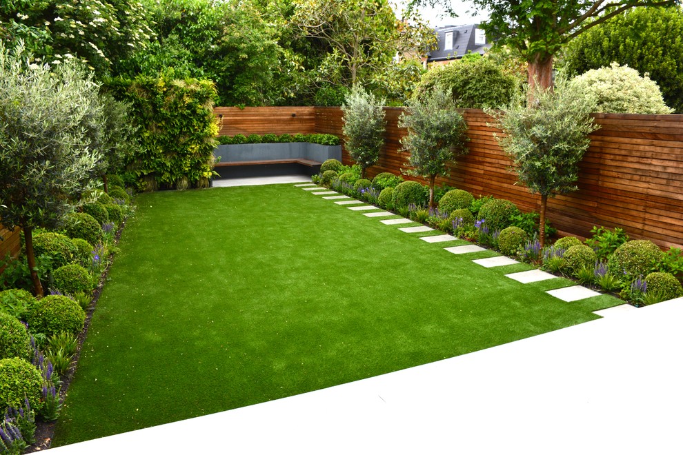 Photo of a medium sized classic back garden in London with a living wall and natural stone paving.
