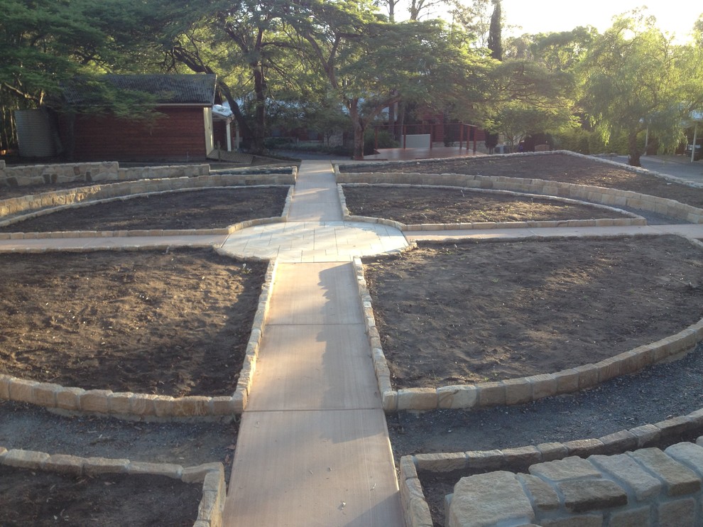Medium sized traditional back garden in Brisbane with a garden path and natural stone paving.