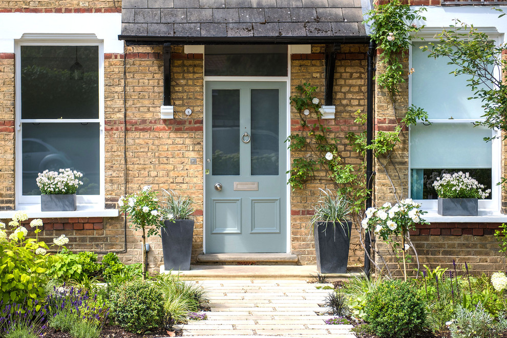 Inspiration for a large traditional front yard stone garden path in London.