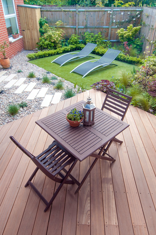This is an example of a small contemporary back partial sun garden in London with decking.