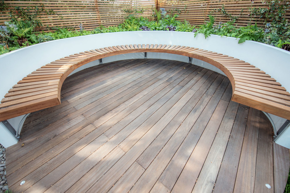 This is an example of a large contemporary back garden in London with decking.