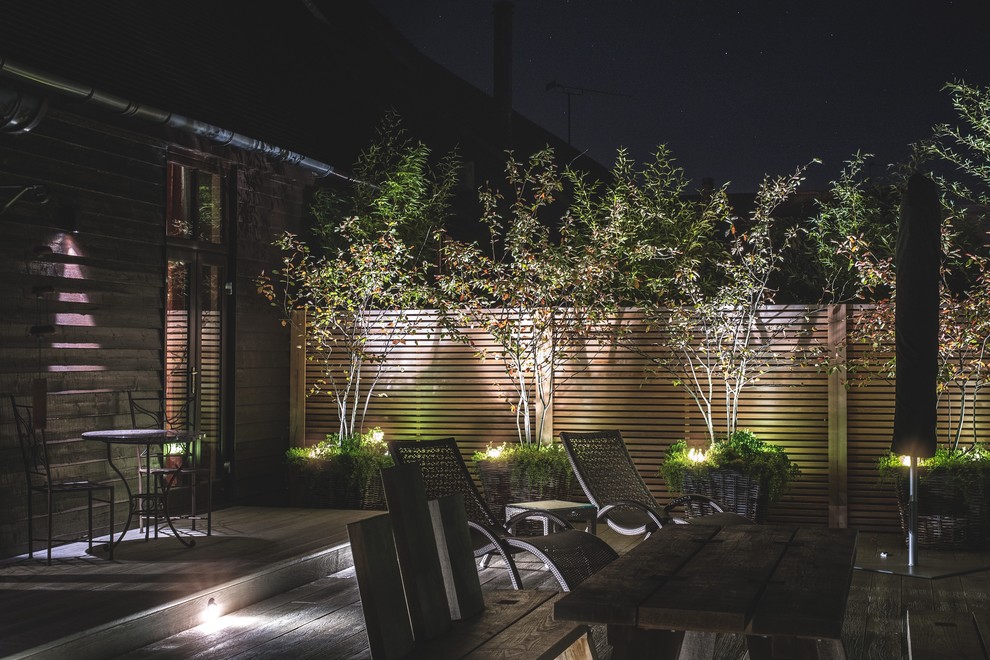 Inspiration for a small contemporary full sun courtyard landscaping in Oxfordshire with decking for summer.