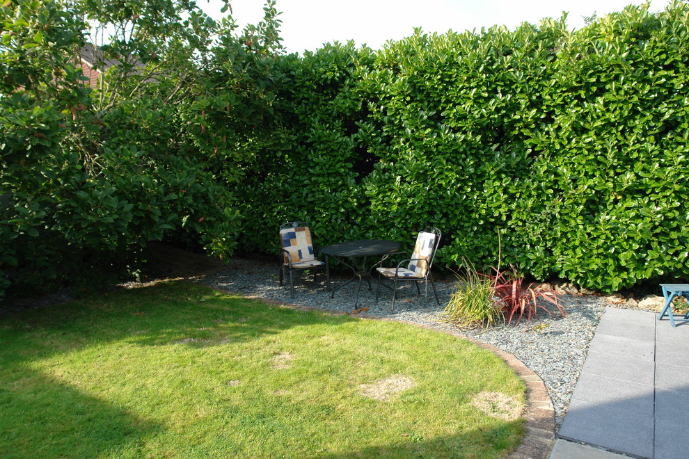 Inspiration for a medium sized contemporary back xeriscape fully shaded garden for summer in Sussex with gravel.