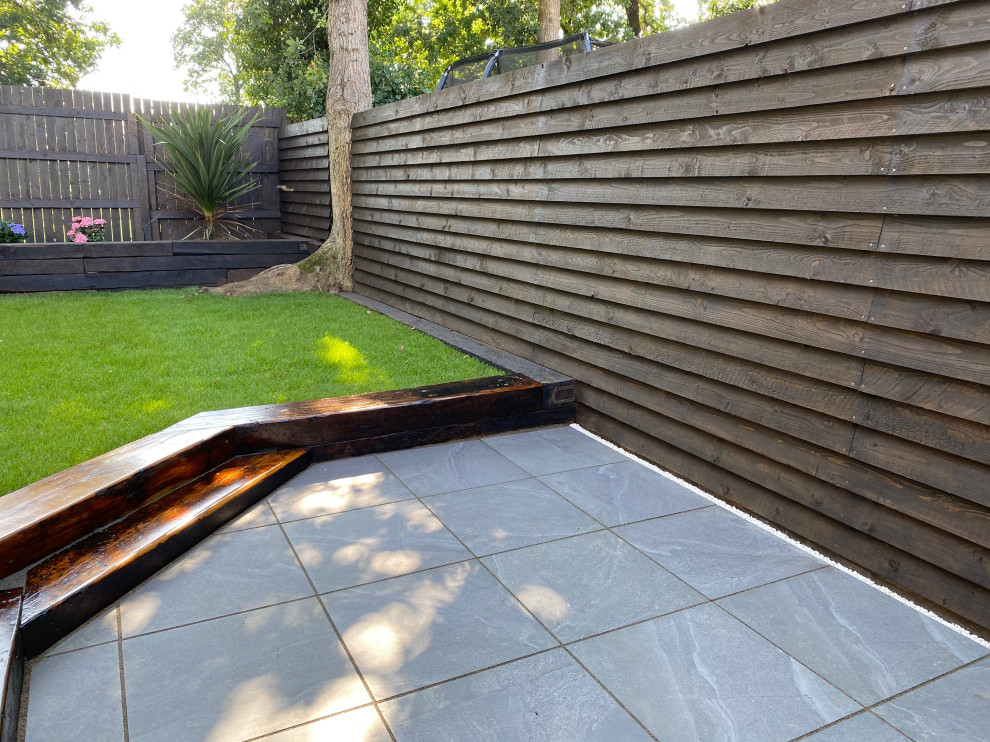 Inspiration for a large modern back formal partial sun garden for summer in Devon with a retaining wall.