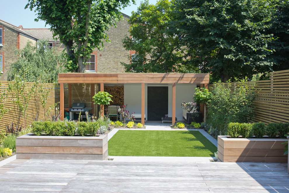 This is an example of a medium sized modern garden in London.