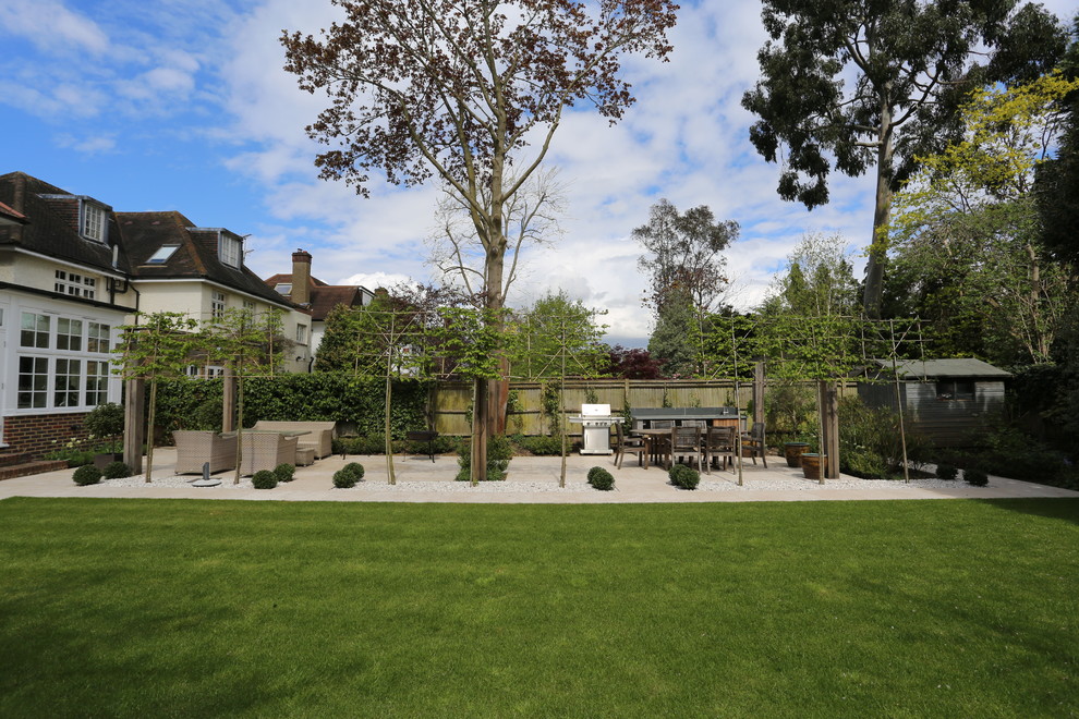 This is an example of a mid-sized traditional backyard stone formal garden in London.