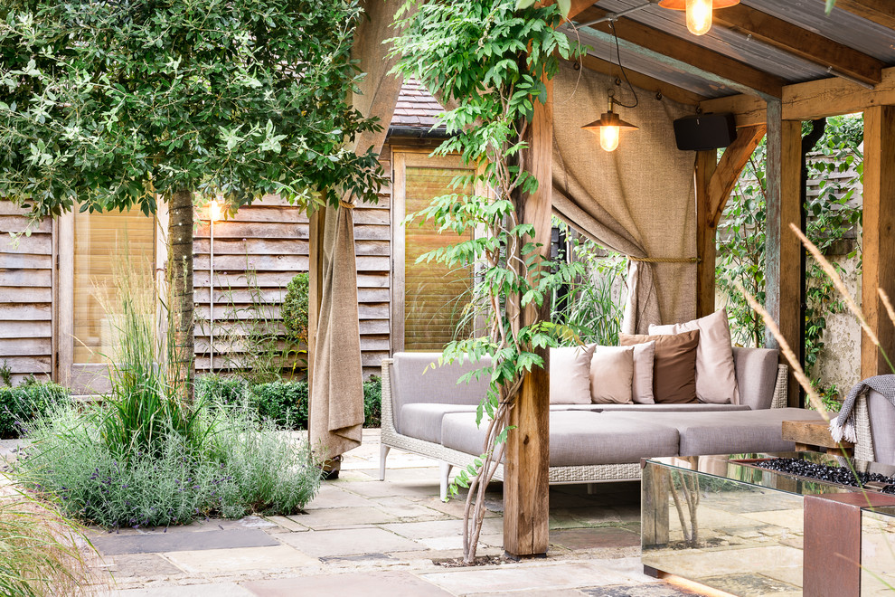 Inspiration for a large rustic courtyard formal full sun garden for summer in Sussex with natural stone paving.