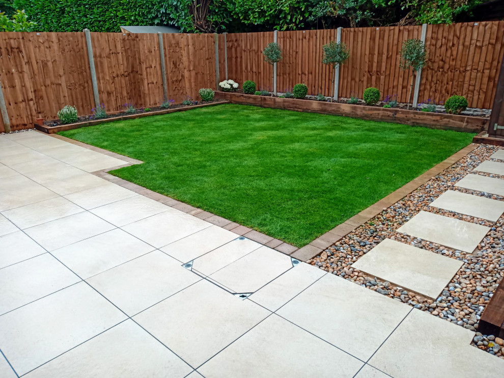Photo of a medium sized modern back formal full sun garden for summer with a pathway.