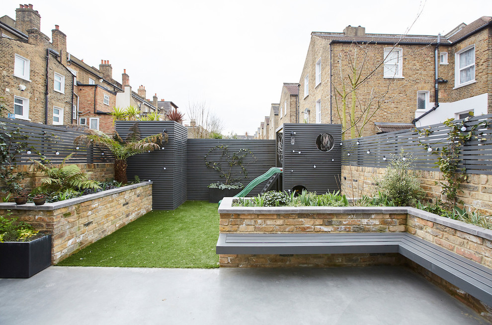 Design ideas for a medium sized contemporary back garden in Sussex with a potted garden and concrete paving.