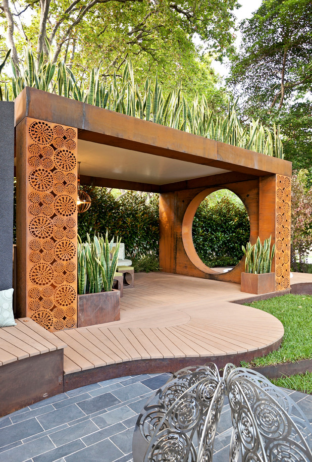 Inspiration for a contemporary backyard landscaping in Melbourne with a fire pit and decking.