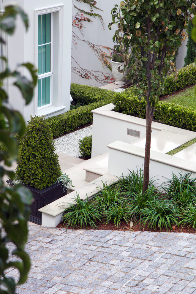 Inspiration for a small contemporary full sun front yard stone garden path in Sydney.