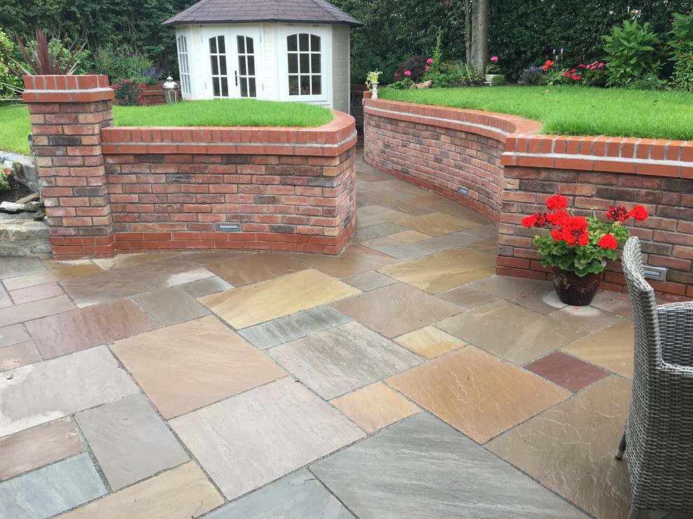 Photo of a rural garden in Other with natural stone paving.