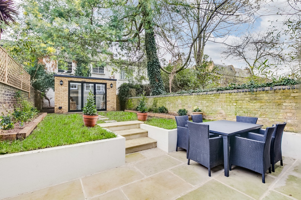 This is an example of a medium sized contemporary back full sun garden in London.