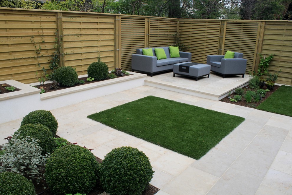 Photo of a mid-sized contemporary backyard landscaping in Kent.