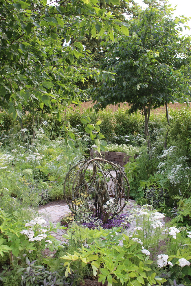 Idee per un piccolo giardino country esposto in pieno sole dietro casa in estate con pavimentazioni in pietra naturale