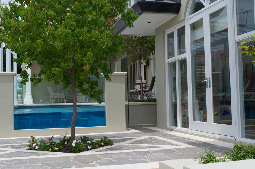 Design ideas for a mid-sized contemporary backyard landscaping in Perth for summer.
