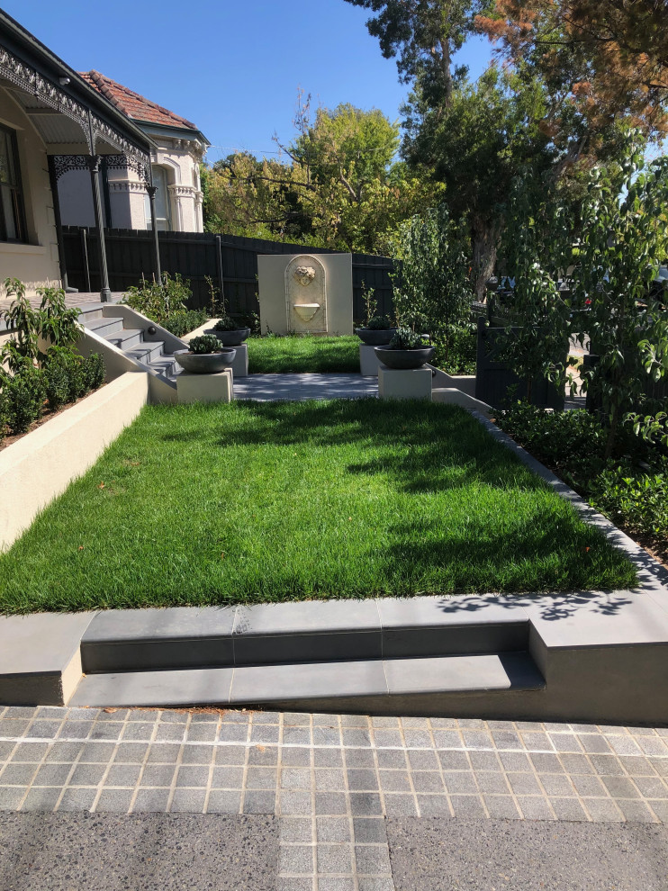 Inspiration for a large contemporary back full sun garden for autumn in Melbourne with natural stone paving.