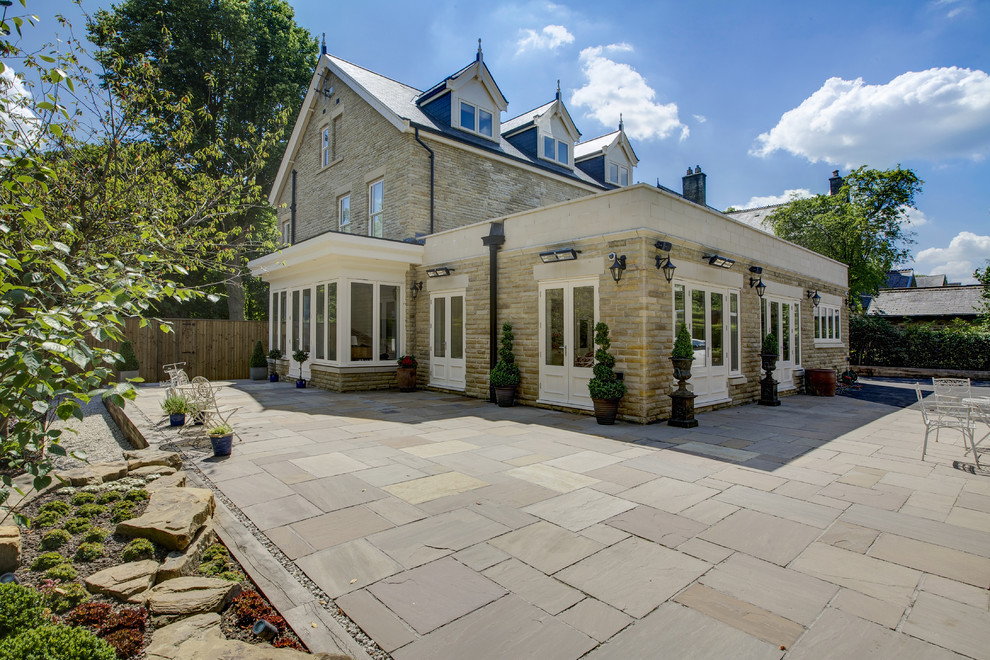 Photo of an expansive classic back garden in Other with natural stone paving.