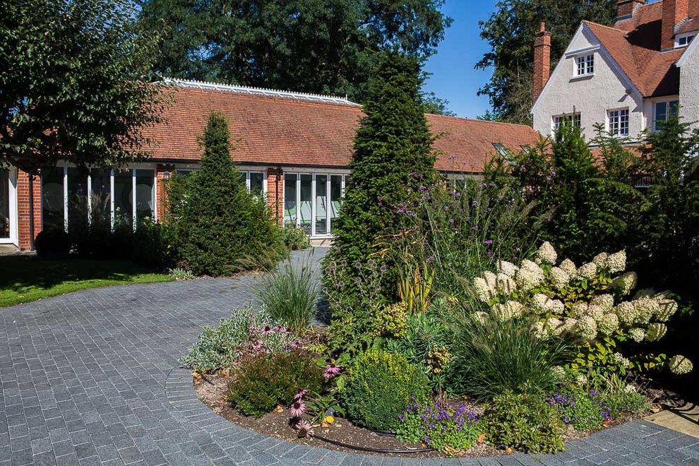 Design ideas for a large classic front driveway full sun garden for summer in Buckinghamshire with a garden path.