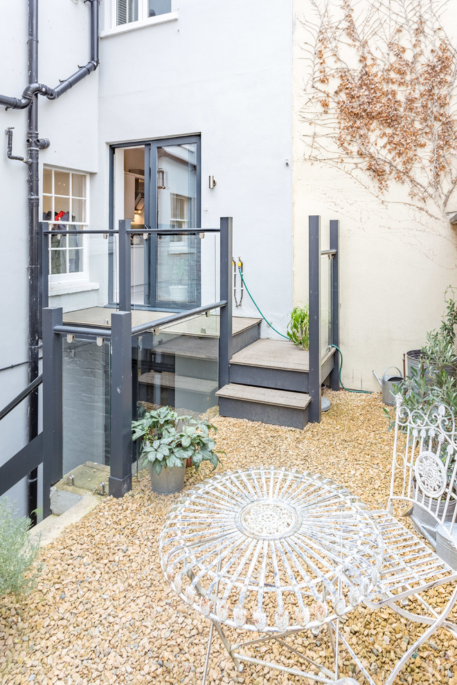 Design ideas for a small contemporary back full sun garden in London with gravel.