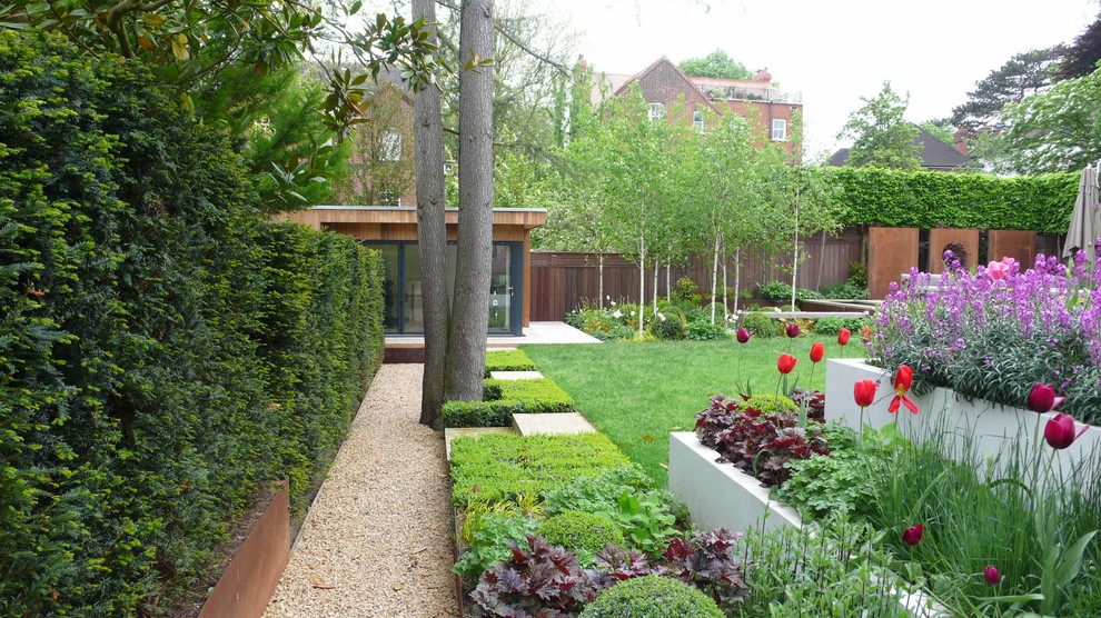 Exemple d'un grand jardin arrière tendance avec une exposition partiellement ombragée et du gravier.