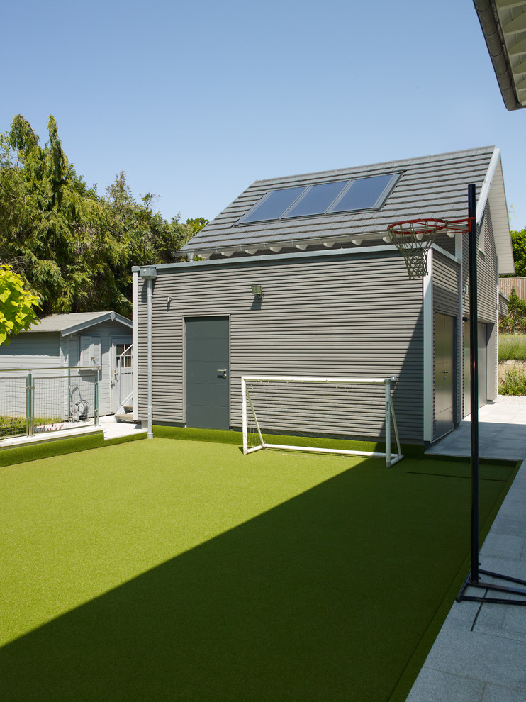 Inspiration for a contemporary back garden in Cambridgeshire with an outdoor sport court.