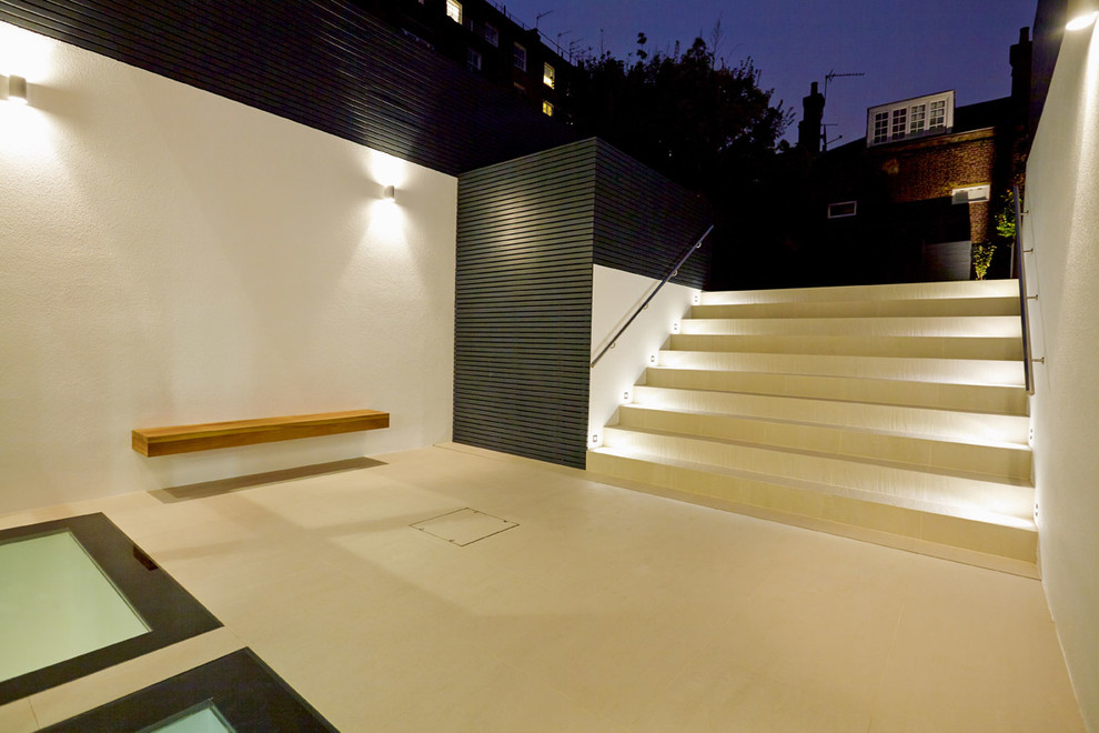 Idee per un giardino design dietro casa con pavimentazioni in pietra naturale