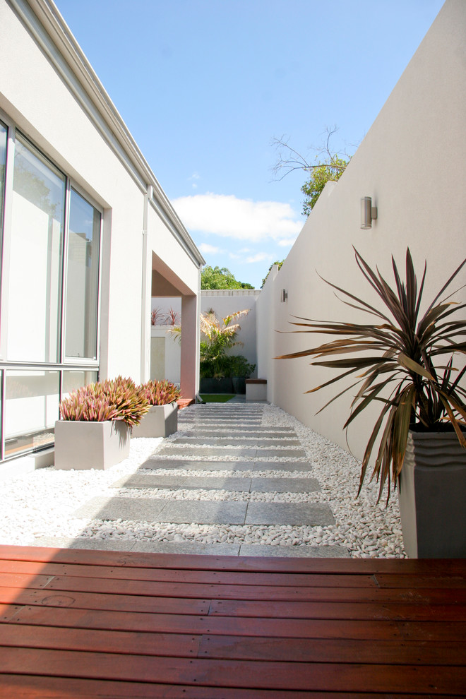 Medium sized contemporary back xeriscape partial sun garden in Perth with decking and a water feature.